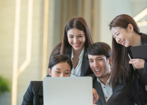 Young Asian business people are meeting in office . Group of Business team working Meeting at the screen monitor